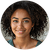 Portrait of a person with natural hair, wearing a black top.