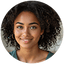 Portrait of a person with natural hair, wearing a black top.