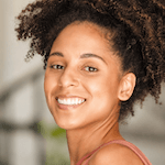 Smiling female athlete carrying a gym bag