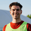 Portrait of a smiling soccer player wearing a training bib.