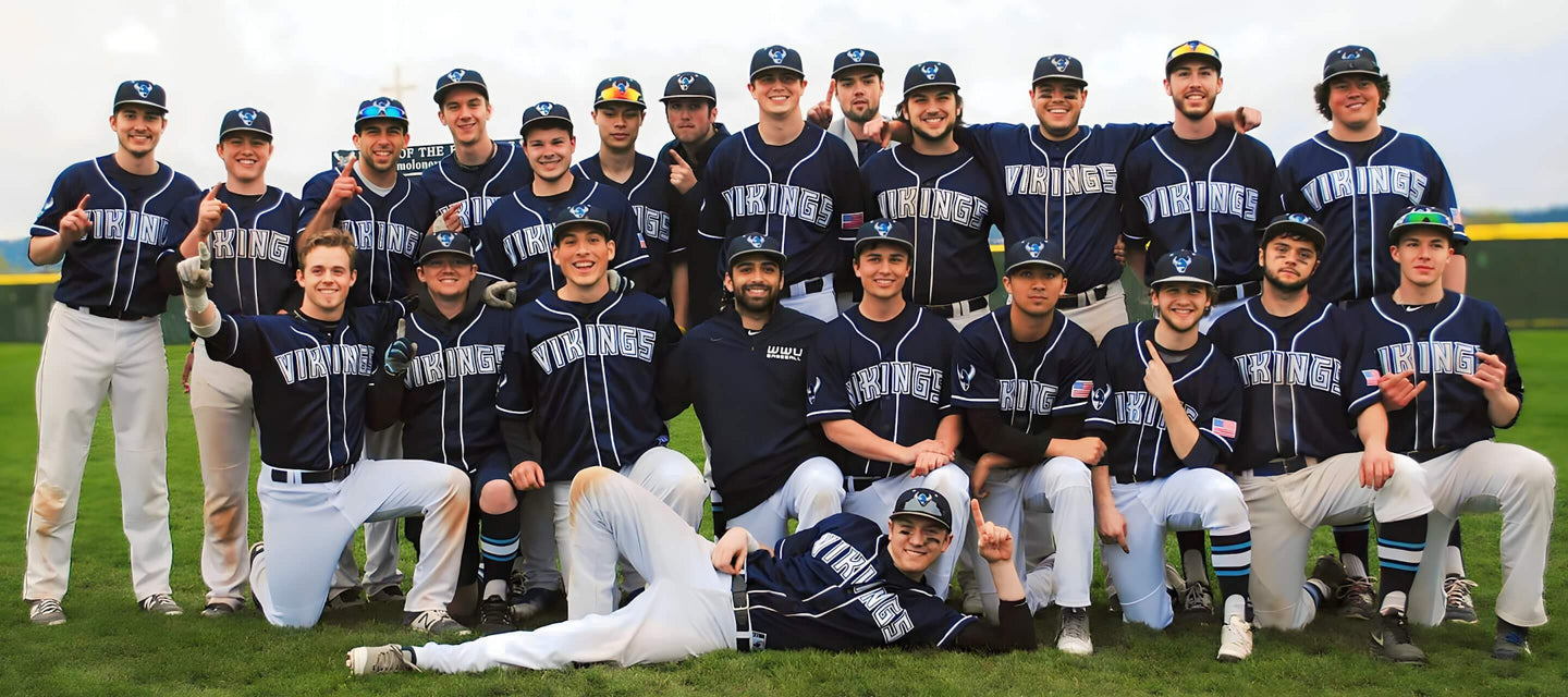A baseball team of 23 players with blue baseball jerseys posing for a team picture